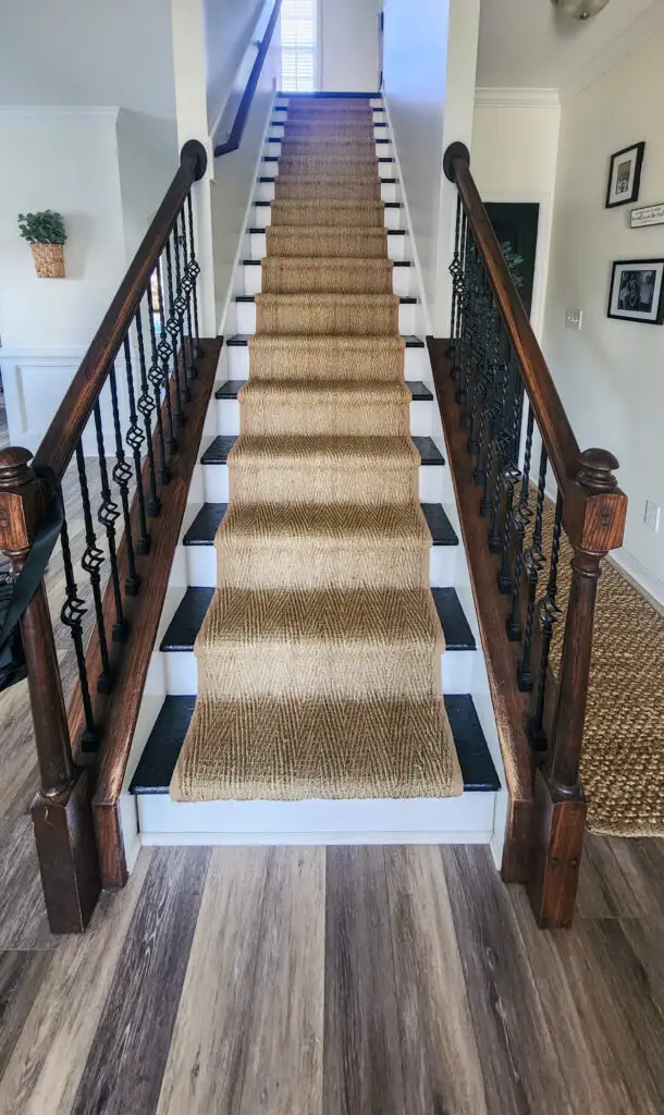 Custom staircase in entryway with new floors by Wynn Building Construction