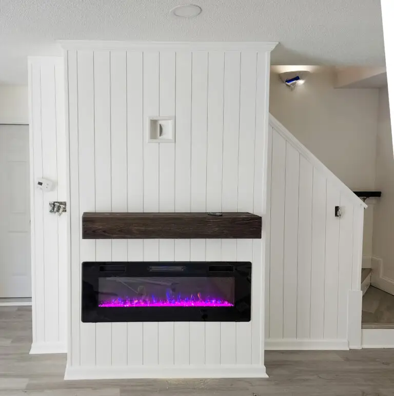 electric fireplace with wainscotting and new floors by Wynn Building Construction