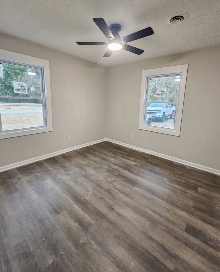 After photo of a bedroom overhauled with professional painting services, flooring installation and more from Wynn Building Construction
