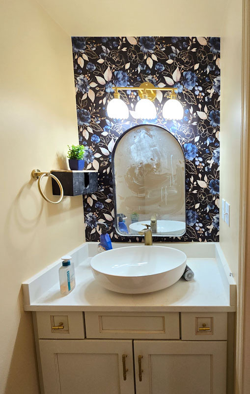 new vanity, lighting and tiling in a renovated bathroom